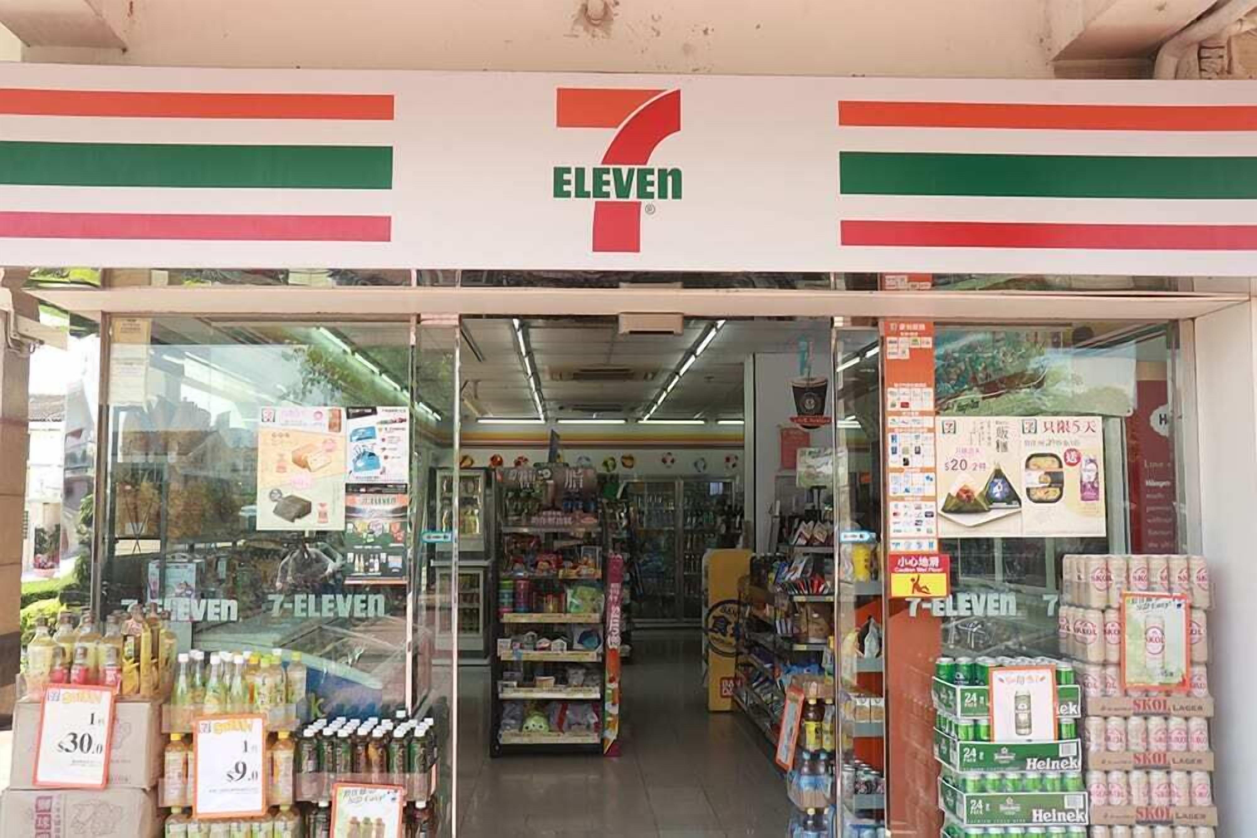 A 7-Eleven convenience store with a variety of products on shelves and in the display windows.
