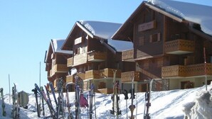 A wooden chalet with balconies and ski equipment in the foreground. - APARTMENT FACING MONT BLANC AND BEAUFORTAIN VALLEY (Villard-sur-Doron)