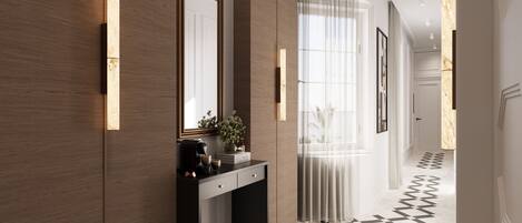 A modern hallway with a checkered floor, a wooden wall, a console table with a mirror, and a pendant light.