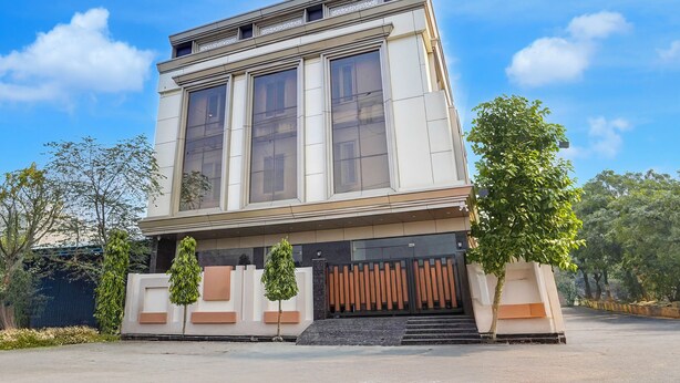 A modern building with large windows and a symmetrical facade. - The Byke Boutique Tejjora (Lucknow)