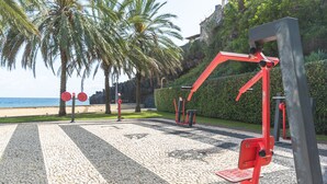 Outdoor exercise equipment, palm trees, and a beach in the background. - Santa Cruz Studio 3 by Atlantic Holiday (Santa Cruz)