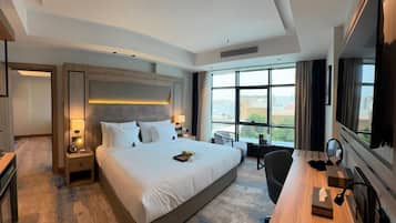 Deluxe Suite, Partial Sea View | In-room safe, laptop workspace, iron/ironing board, free WiFi