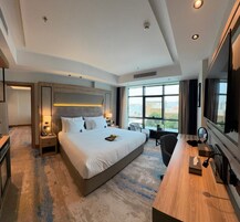 Deluxe Suite, Partial Sea View | In-room safe, laptop workspace, iron/ironing board, free WiFi