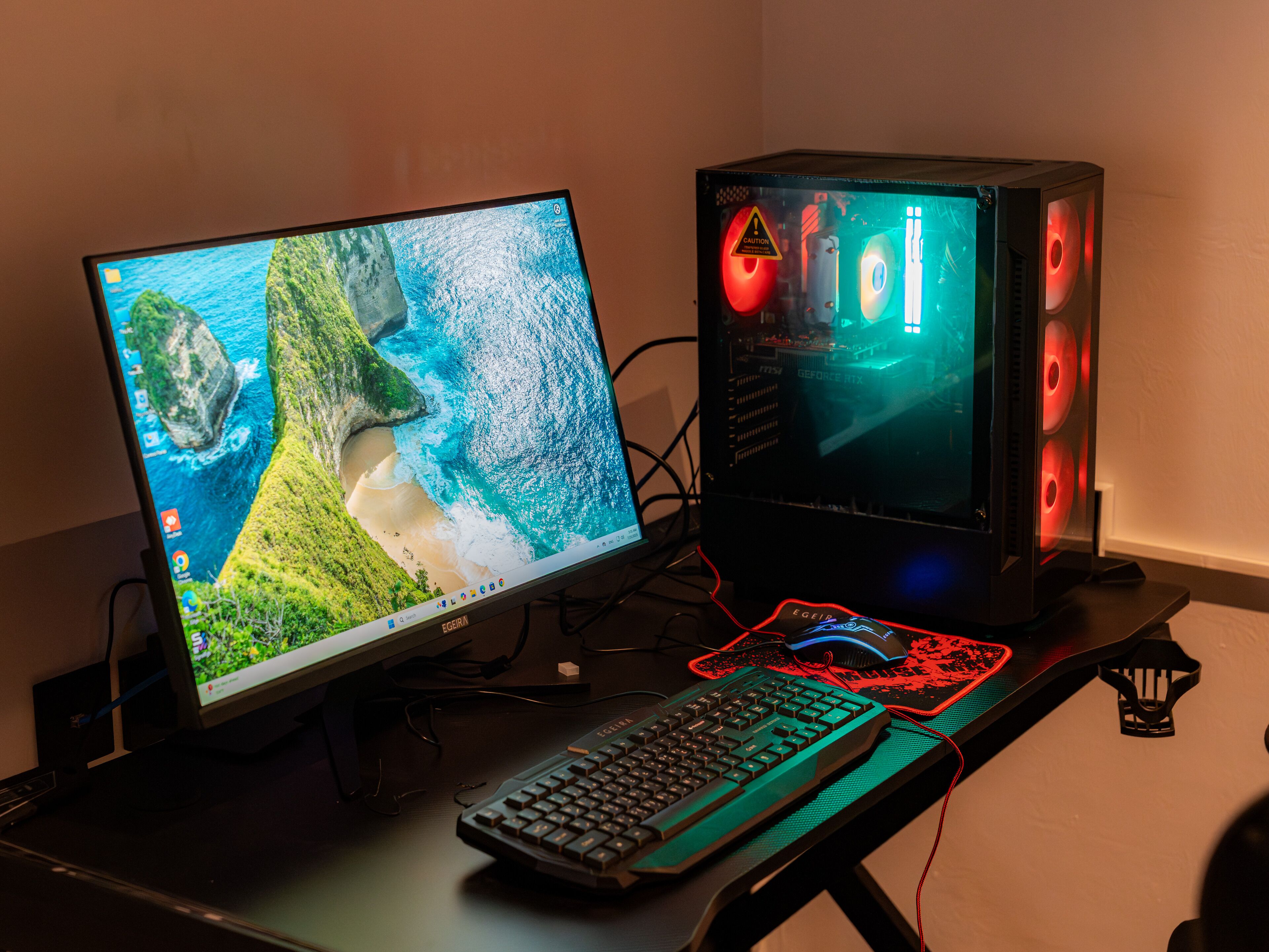 A desktop computer setup with a monitor, keyboard, and tower, connected by visible cables.