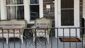 A porch with two wicker chairs, a white mailbox with the number 234, and a welcome mat. - Relax & Recharge: Your Dream Stay in Port Carbon! (Port Carbon)