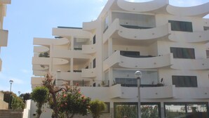 A multi-story building with balconies and large windows. - The Shell House (Manta Rota)