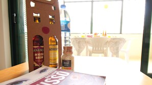 A table with a book, a bottle of water, and a bottle of beer. - The Shell House (Manta Rota)