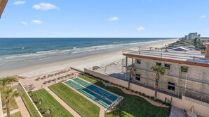 A beachfront hotel with a pool, lounge chairs, and a view of the ocean. - 510 - Cozy 1 bedroom Fantastic View (New Smyrna Beach)