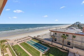 A beachfront hotel with a pool, lounge chairs, and a view of the ocean. - 510 - Cozy 1 bedroom Fantastic View (New Smyrna Beach)