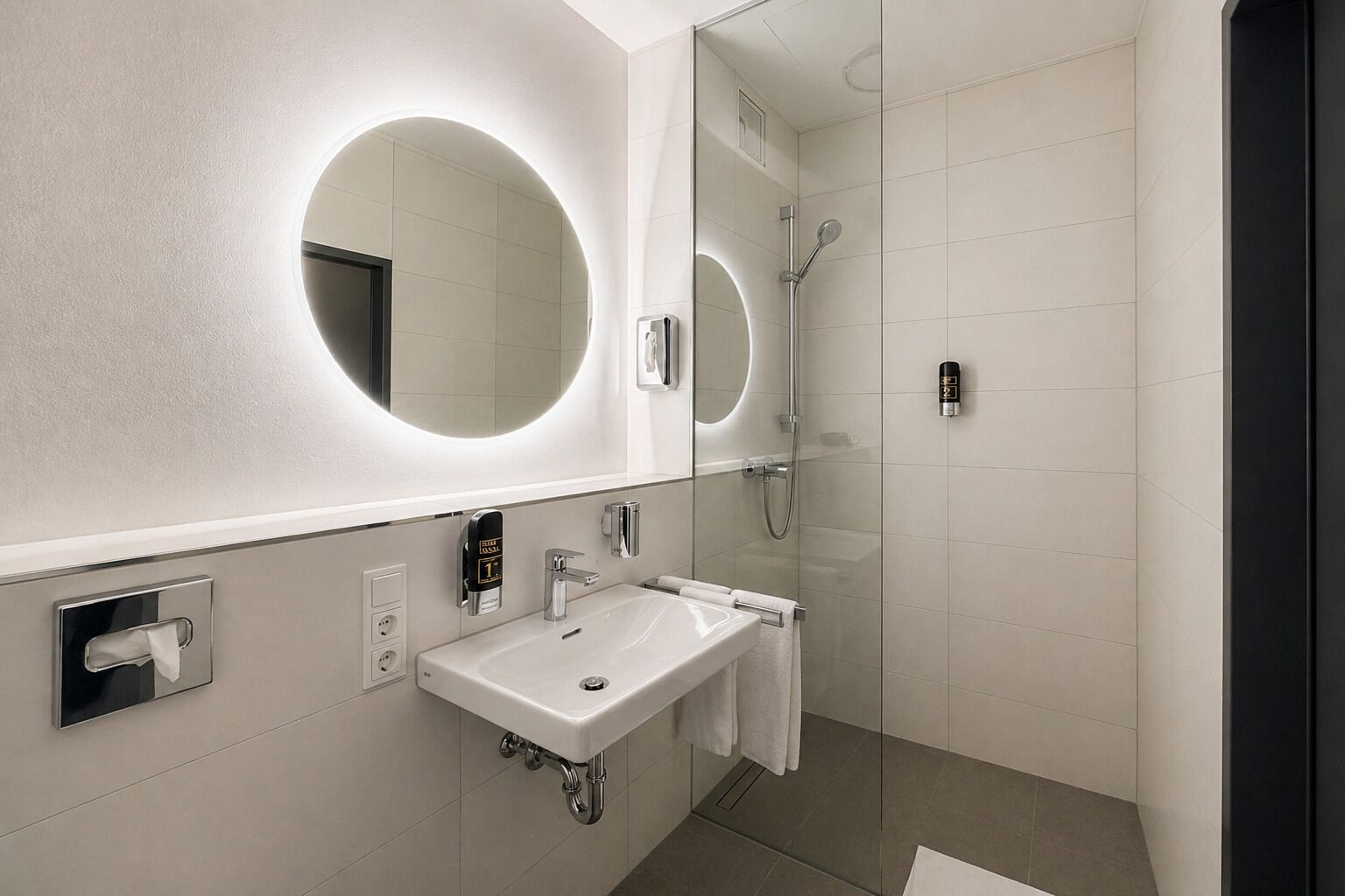 A modern bathroom with a large mirror, a sink, a shower, and a towel rack.
