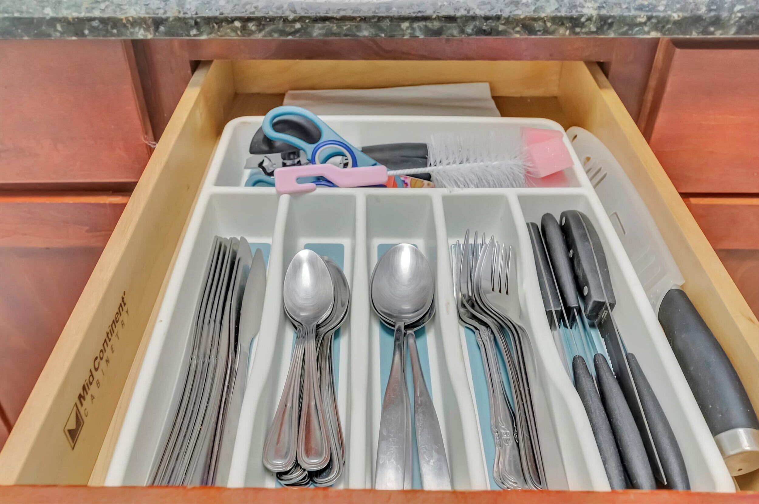 A drawer with utensils and kitchen tools.