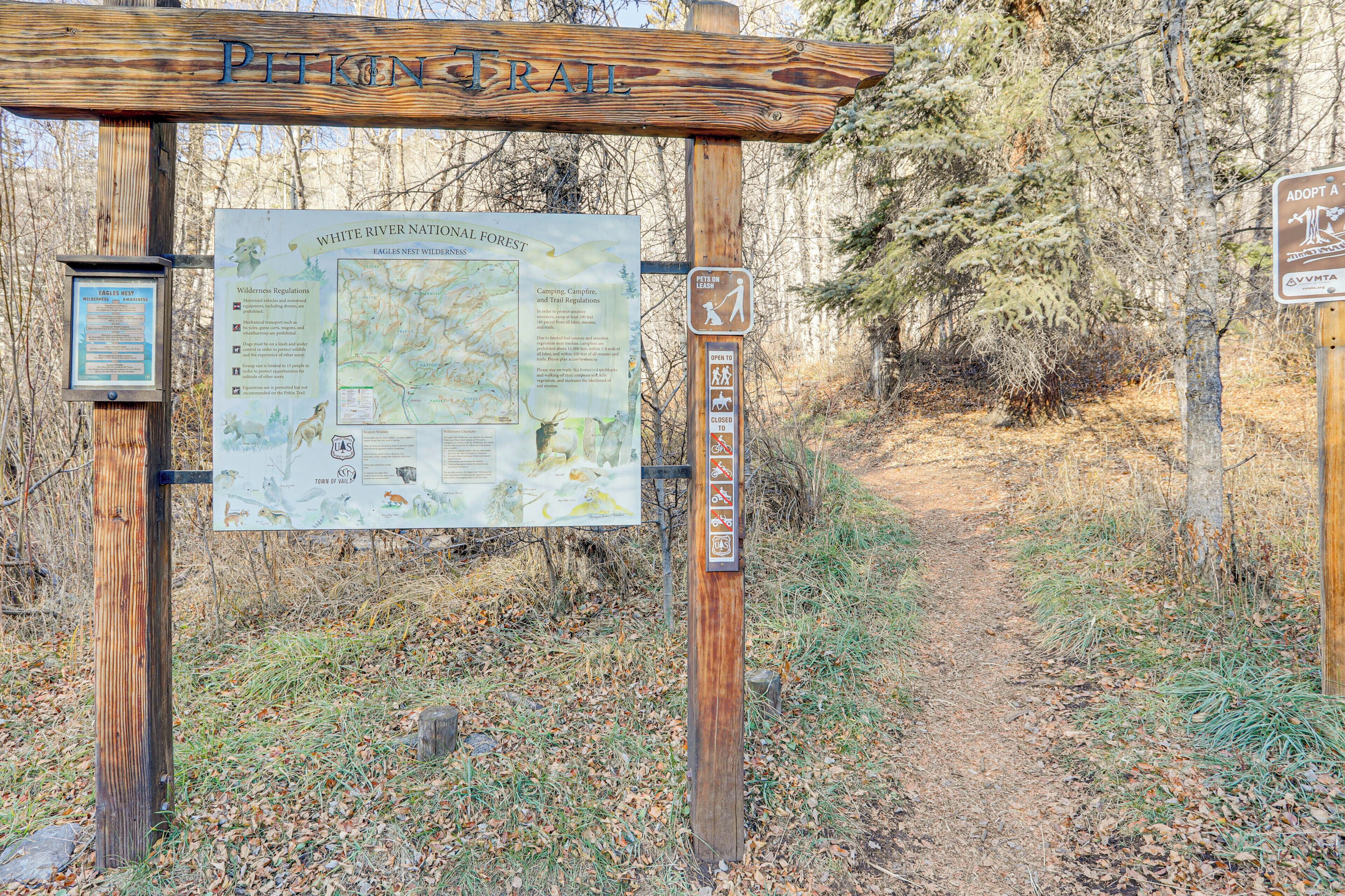 Un panneau indicateur en bois, muni d’une carte et d’affiches d’information sur la forêt nationale de White River.