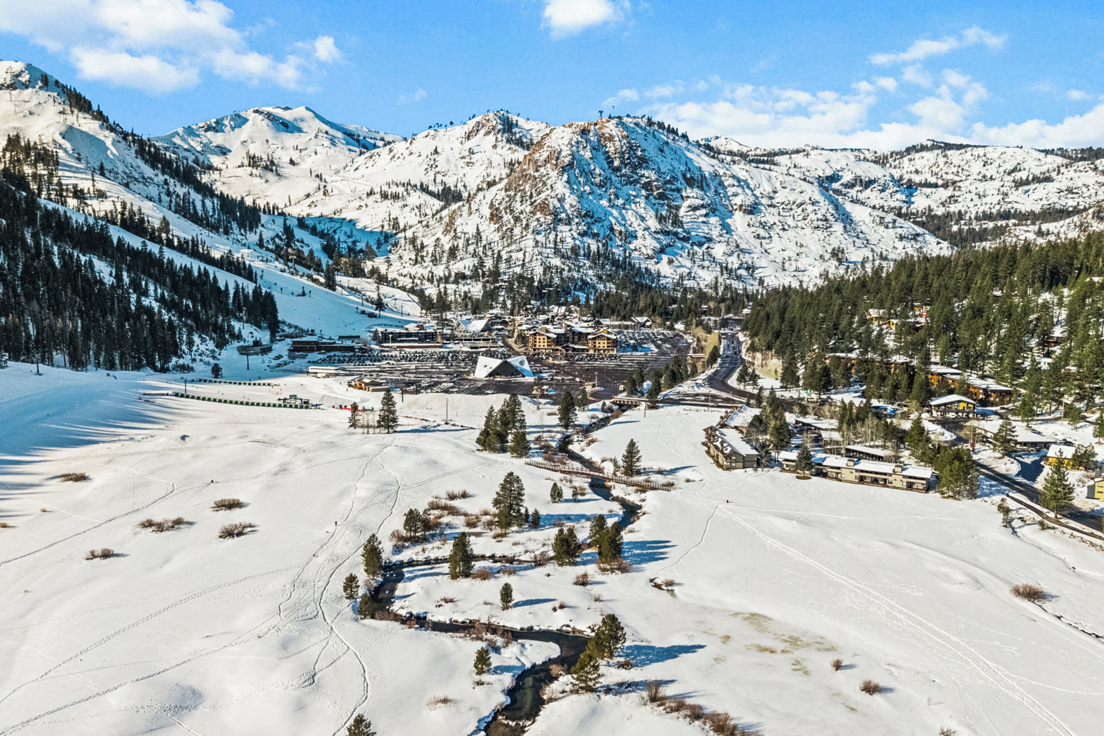 A snow-covered mountain landscape with a small village and buildings.
