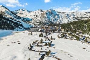 A snow-covered mountain landscape with a small village and buildings. - Scenic Valley Views! Cozy Everline Resort Getaway (Olympic Valley)
