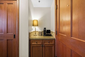 A small kitchenette with wooden cabinets, a coffee maker, and a lamp on the countertop. - Scenic Valley Views! Cozy Everline Resort Getaway (Olympic Valley)