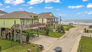 A beachfront property with a wooden deck, a covered walkway, and a view of the ocean. - Steps to Shore! 'just Beachy' Home w/ Deck + Views (Port Bolivar)