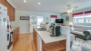 A modern kitchen with wooden cabinets, a built-in oven, and a coffee maker.