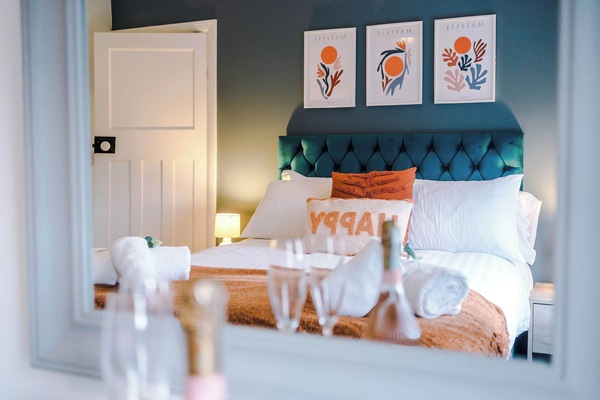 This vibrant bedroom is the perfect place for a great night's sleep, featuring a comfy double bed, chest of drawers, bedside tables and a hanging rail for your belongings.