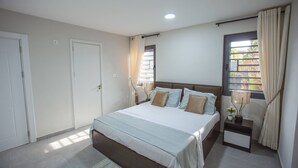 A bedroom with a bed, bedside tables, a window with curtains, and a door. - The Oasis Airport Pick up Wifi Central (Accra)
