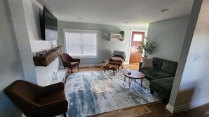 A living room with a sofa, two armchairs, a coffee table, and a patterned rug. - Adorable 3-bedroom 2-bath House in quiet, safe, kid/pet friendly neighborhood. (Enfield)