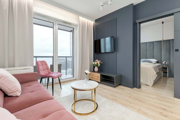 Contemporary living zone with charcoal cabinetry and subtle decorative elements.