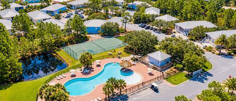 A residential area with multiple houses, a swimming pool, and a tennis court.