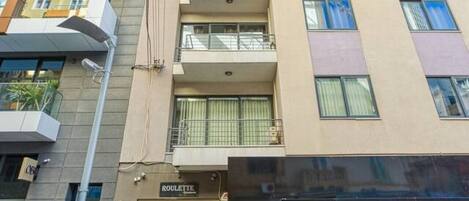 A multi-story building with a ground-level restaurant named "ROULETTE" and a visible entrance.
