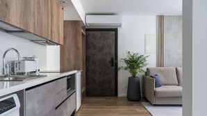 A modern kitchen with a built-in dishwasher, a stainless steel sink, and a large window. - Modern Studio Suite w/ Balcony & Queen Bed – Germasogeia Tourist Area, Limassol (Germasogeia)