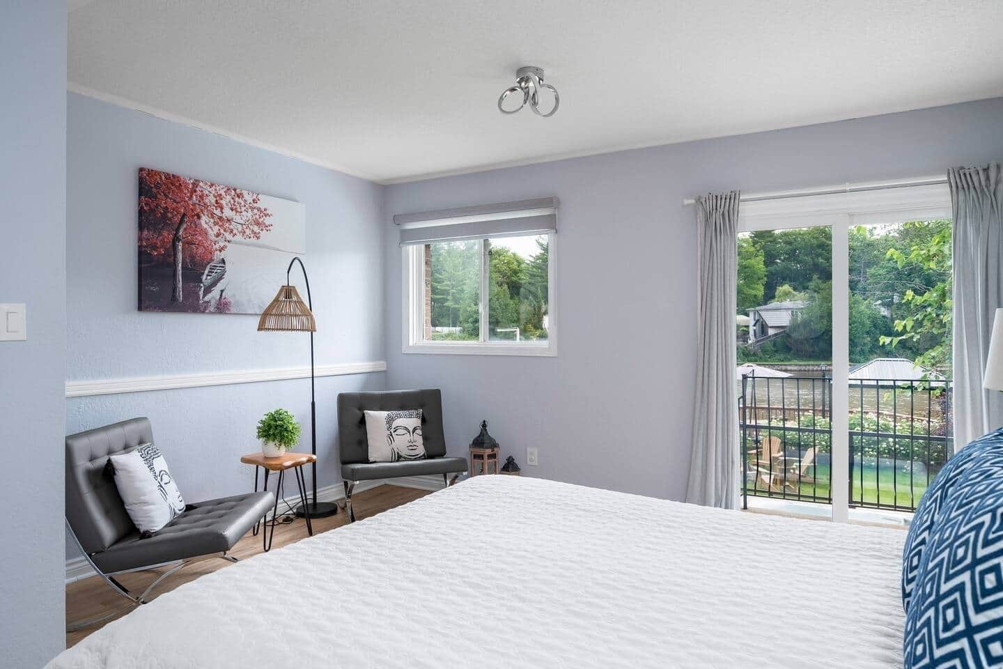 The master bedroom not only offers stunning river view but also features a cozy conversation set. This inviting seating area is perfect for unwinding with a book, enjoying morning coffee, or simply soaking in the serene scenery through the window.
