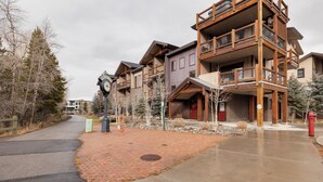 A multi-story building with a brick pathway and a red fire hydrant.
