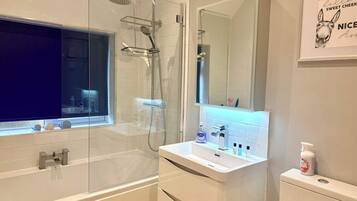 Shower, hair dryer, towels, shampoo