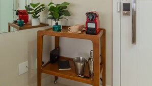 A modern bathroom with a wooden vanity, a mirror, a coffee machine, and a refrigerator. - 5 Minutes From Copacabana Beach B703 (Rio de Janeiro)