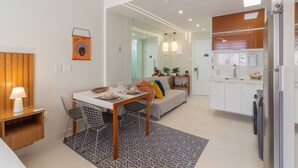 A modern kitchen with white cabinets, a built-in oven, and a refrigerator. - 5 Minutes From Copacabana Beach B703 (Rio de Janeiro)