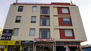 A multi-story building with a sign for HOTEL NILAX. - Hotel Nilax (Jaipur)