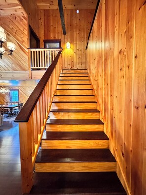 A wooden staircase with a railing, leading to a balcony. - Private, Comfy Cabin in Rangeley/Trails, Lakes, Fire Pit/Sleeps 8/Starry Sky (Rangeley)