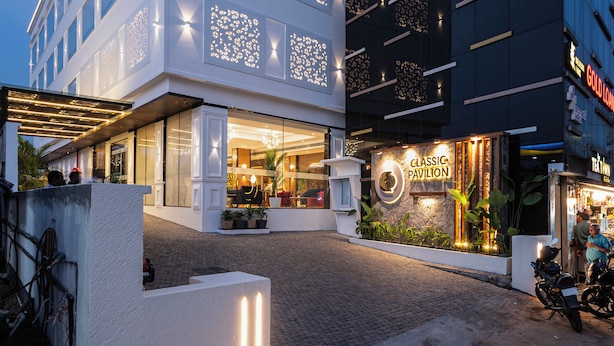 A building with a sign reading "CLASSIC PAVILION" and a modern architectural design with illuminated patterns. - Hotel Classic Pavilion (Thiruvananthapuram)