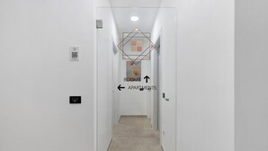 A narrow hallway with directional signs indicating 'ROOMS' and 'APARTMENTS' with arrows. - Room 'Camera 1 - P2' with Balcony, Wi-Fi and Air Conditioning (Balestrate)