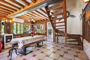 A rustic dining area with a wooden table, chairs, and a chandelier. - Guest Room “Chambre Camélia” with Breakfast Included (Lieurey)