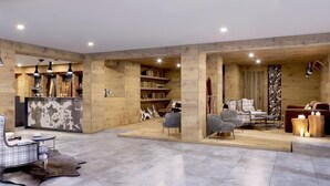 A spacious living area with a wooden interior, a fireplace, and a seating area with chairs and a sofa. - Le Mallet, Courmayeur, Alpine Homesuite (Courmayeur)