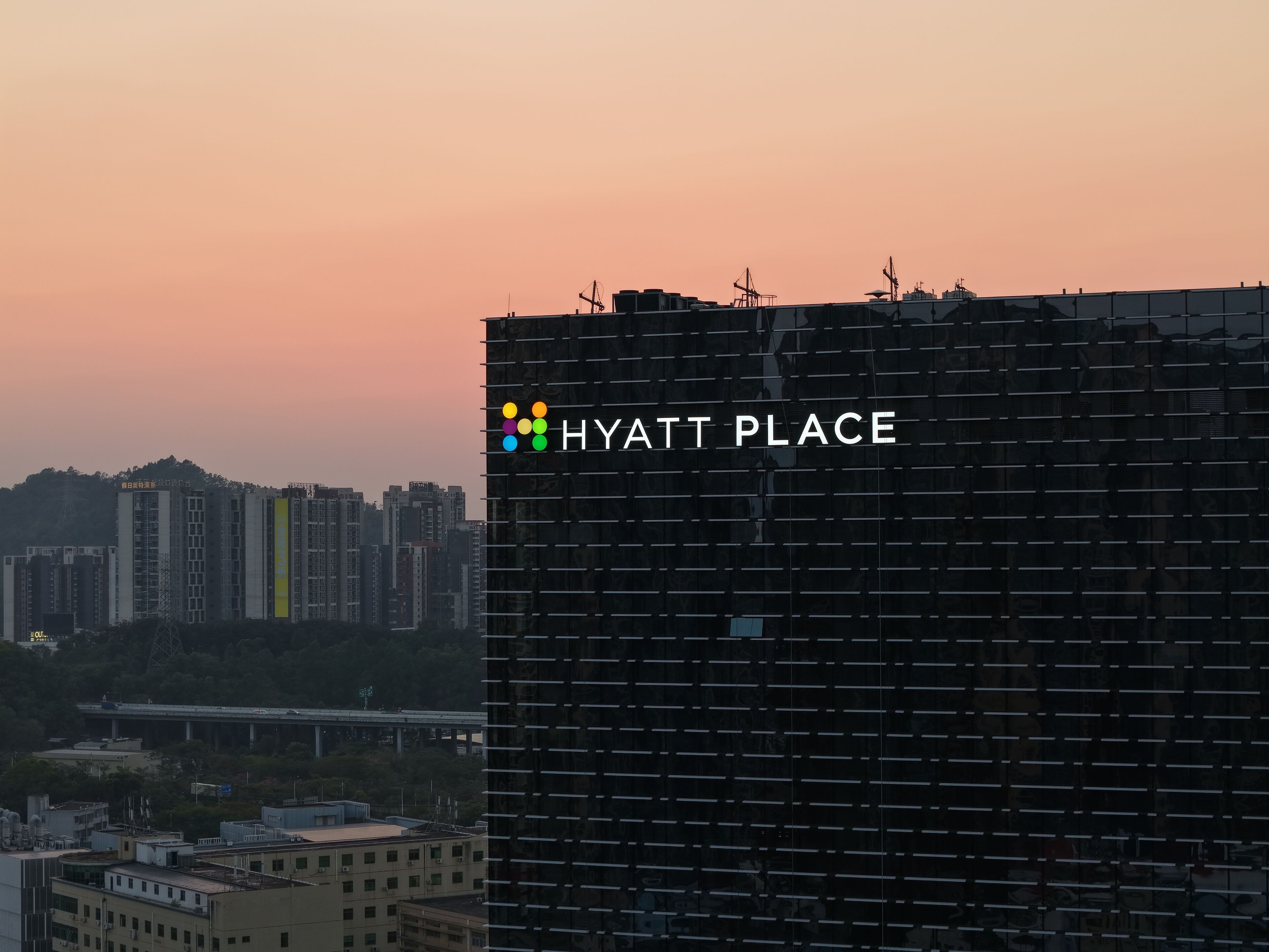 A modern building with the text "HYATT PLACE" and a logo.