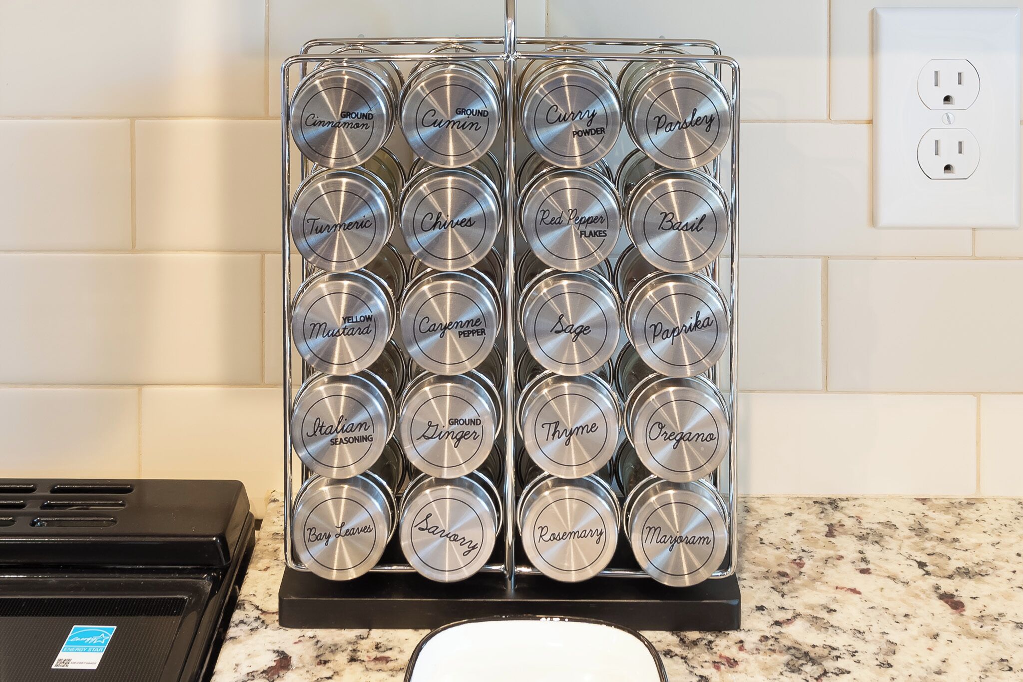 A spice rack with various labeled containers.