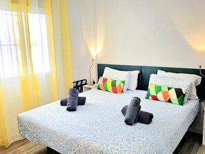 A hotel room with a bed, pillows, a nightstand, and a lamp. - Elegant urban retreat in Torremolinos with panoramic terraces (Torremolinos)