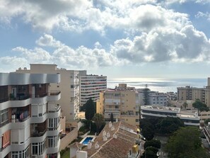 A coastal cityscape with multi-story buildings, a clear sky, and a view of the sea. - Elegant urban retreat in Torremolinos with panoramic terraces (Torremolinos)
