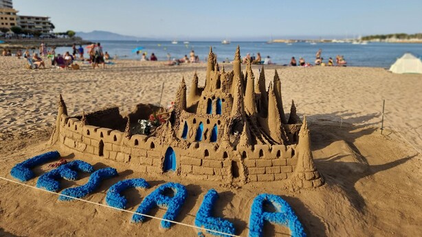 Un castillo de arena con la palabra 