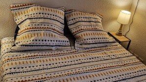 A bed with a patterned bedspread and two pillows. - 2-Room Apt 4 People, South Balcony, Parking (Valloire)