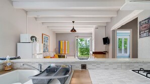 A kitchen with a sink, dish rack, and a stove. There is a window with a view of greenery outside. - Gite Cantou – Friendly Holiday Home with Shared Heated Pool in the Heart of Périgord Noir (Salignac-Eyvigues)