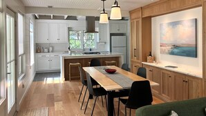 A modern kitchen with white cabinets, a wooden island, and pendant lighting. - Away - Ocracoke Island (Ocracoke)