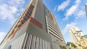 A high-rise building with a modern architectural design, featuring a prominent vertical structure and multiple balconies. - Comfort Near Allianz Parque Sp-p1804b (São Paulo)