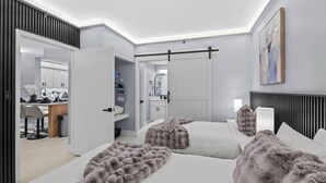 Een moderne hotelkamer met twee bedden, een bureau en een badkamer.