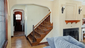 A staircase with wooden steps and a metal railing leading to a second floor. - Quaint & Cozy Indiana Style (Shelbyville)